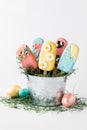 Homemade cakesicles decorated for Easter, in a tin pail. Royalty Free Stock Photo