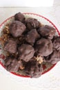 Homemade candy made from nuts and dried fruits. Some are covered in chocolate. They lie on a plate Royalty Free Stock Photo