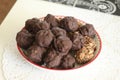 Homemade candy made from nuts and dried fruits. Some are covered in chocolate. They lie on a plate Royalty Free Stock Photo