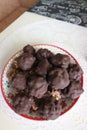 Homemade candy made from nuts and dried fruits. Some are covered in chocolate. They lie on a plate Royalty Free Stock Photo