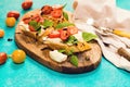 Homemade caprese bruschetta with flavorful cherry tomatoes, fresh basil, mozzarella and crispy bread Royalty Free Stock Photo