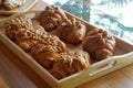 Picture Homemade caramel croissant, delicious tender meat in a wooden tray.