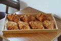 Picture Homemade caramel croissant, delicious tender meat in a wooden tray.