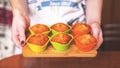 Homemade caramel muffins in a baking dish in the hands of the confectioner