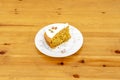 Homemade carrot cake with nuts, cinnamon, raisins and sunflower seeds on white plate Royalty Free Stock Photo