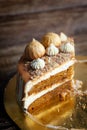 Homemade Carrot Cake with salted caramel decorated with meringues, ground nuts and cream Royalty Free Stock Photo