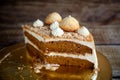 Homemade Carrot Cake with salted caramel decorated with meringues, ground nuts and cream Royalty Free Stock Photo