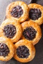 Homemade Cebularz Lubelski Polish round flatbread stuffed with red onion and poppy seeds close-up on a wooden board on the table.