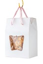 Homemade cereal cookies in paper box gift is hanging on white ba