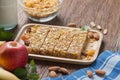 Homemade Cereal granola bars with nuts and garnola, milk bottle, apple, banana on wooden desk, Energy food, Healthy snack Royalty Free Stock Photo