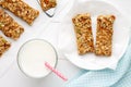 Homemade cereal snacks for healthy eating. Granola bars with milk on white wooden background. Royalty Free Stock Photo