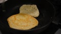 Homemade chapati flat pancake-like bread cooked on a griddle with oil