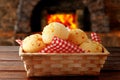 Homemade cheese bread, traditional Brazilian snack, in the basket after leaving the oven on a rustic kitchen table Royalty Free Stock Photo