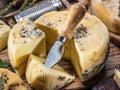 Homemade cheese with herbs on the wooden background.