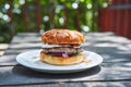 Homemade cheeseburger made from melted beef, cheese and vegetables from orgnic farming. Royalty Free Stock Photo