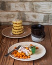 Homemade cheesecakes on two plates with frozen sea buckthorn berries and a coffee mug Royalty Free Stock Photo