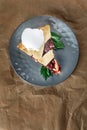 Homemade cherry cobbler pie with flaky crust, ice cream. 45 view, the plate is on craft paper. Royalty Free Stock Photo