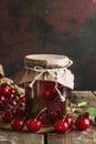 Homemade Cherry Jam in Glass Jar with Fresh Cherries on Wooden Table Royalty Free Stock Photo
