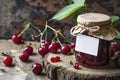 Homemade Cherry Jam in Glass Jar with Fresh Cherries on Wooden Table Royalty Free Stock Photo