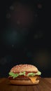 Homemade cheeseburger side view on wooden table have blurred night life vertical background with bokeh effect