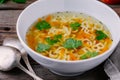 Homemade Chicken and Alphabet Soup with carrots and parsley in bowl