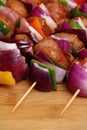 Homemade Chicken and Bacon Skewers Kebabs with Peppers Onions and Herb Marinate on wooden background Royalty Free Stock Photo