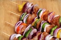 Homemade Chicken and Bacon Skewers Kebabs with Peppers Onions and Herb Marinate on wooden background Royalty Free Stock Photo