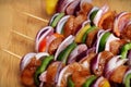 Homemade Chicken and Bacon Skewers Kebabs with Peppers Onions and Herb Marinate on wooden background