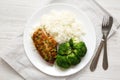 Homemade Chicken Breast, Rice and Broccoli on a white plate on a white wooden surface, top view. Flat lay, overhead, from above Royalty Free Stock Photo