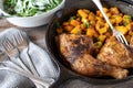 Roasted chicken legs with vegetable and green salad in skillet Royalty Free Stock Photo