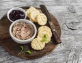 Homemade chicken liver pate, cranberry sauce and homemade cheese biscuits. Delicious snack or appetizer with wine. Royalty Free Stock Photo