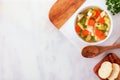 Homemade chicken noodle soup with vegetables, overhead on white marble with copy space Royalty Free Stock Photo