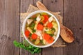 Homemade chicken noodle soup with vegetables, top view on a wood background Royalty Free Stock Photo