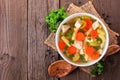 Homemade chicken noodle soup with vegetables, top view against rustic wood Royalty Free Stock Photo