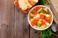 Homemade chicken noodle soup with vegetables, top view table scene on wood with copy space Royalty Free Stock Photo