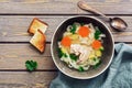 Homemade chicken noodle soup on a wooden rustic plank table. Top view, copy space