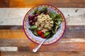 Homemade chicken salad served in a pretty bowl with spinach kalamata olives and cherry tomatoes - on rough wood table Royalty Free Stock Photo