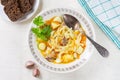 Homemade chicken soup with noodles and vegetables with celery greens on a white tablecloth Royalty Free Stock Photo