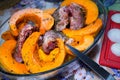 Homemade Chicken thighs and pumpkin pieces bakingin glass form. Royalty Free Stock Photo