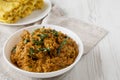 Homemade Chicken Tikka Masala in a white bowl on a white wooden background, low angle view. Space for text Royalty Free Stock Photo