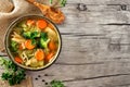 Homemade chicken vegetable soup, above side border on rustic wood Royalty Free Stock Photo