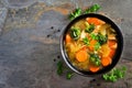 Homemade chicken vegetable soup, overhead on slate
