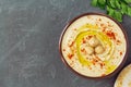 Homemade chickpea hummus bowl decorated with boiled chickpeas, herbs, olive oil and pita bread over gray background Royalty Free Stock Photo
