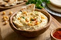 Homemade chickpea hummus bowl with pita chips and paprika