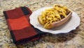 Homemade chili dog with cheddar cheese on a white plate. Royalty Free Stock Photo