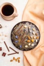 Homemade chocolate brownie cake with caramel cream and almonds with cup of coffee on a white concrete  background. top view, close Royalty Free Stock Photo