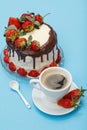 Homemade chocolate cake decorated with fresh strawberries on glass plate and cup of coffee with saucer Royalty Free Stock Photo