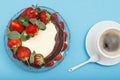 Homemade chocolate cake decorated with fresh strawberries on glass plate and cup of coffee with saucer Royalty Free Stock Photo