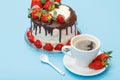 Homemade chocolate cake decorated with fresh strawberries on glass plate and cup of coffee with saucer Royalty Free Stock Photo