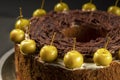 Homemade chocolate cake sweet pastry dessert with brown icing, green decorative cherries